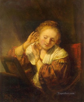 Rembrandt van Rijn Painting - Mujer joven probando aretes Rembrandt